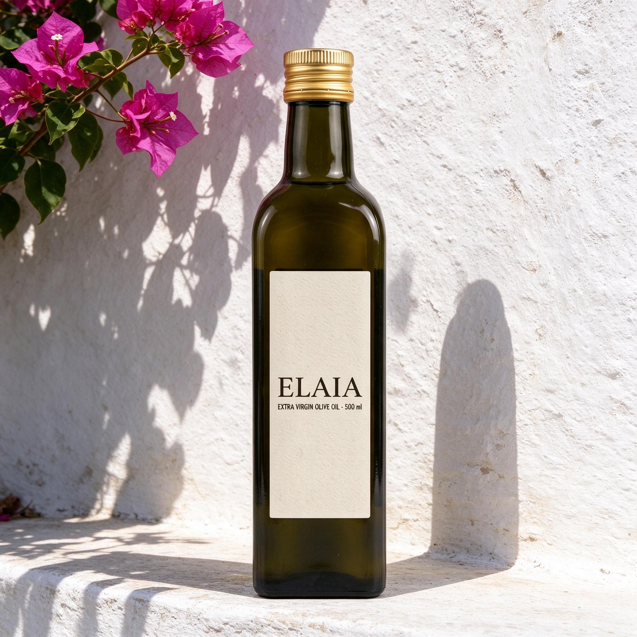 Olive oil bottle on a sunlit whitewashed ledge beneath magenta bougainvillea